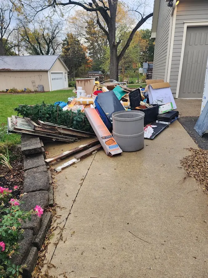 Dumpster being loaded with debris for 12 Yard Dumpster Rental in Etna